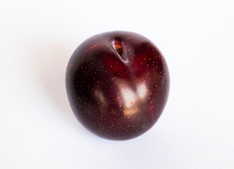 close up of a red cherry plum isolated