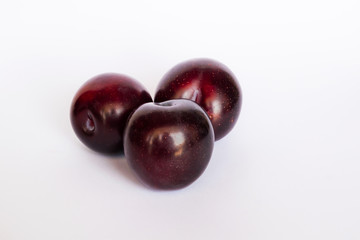 close up of red cherry plums isolated