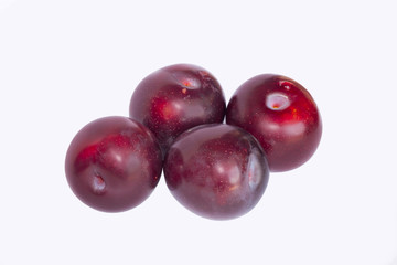 close up of red cherry plums isolated