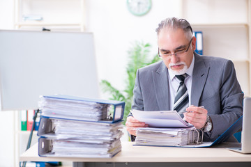 Aged male employee unhappy with excessive work 