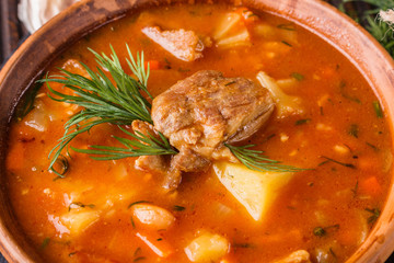 Chanahi a traditional Georgian meat stew in a bowl on stoyn board
