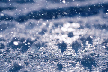 Texture of ice in winter. Pieces of frozen water on a street in the winter. The texture and texture of the frozen water in winter and outdoors.