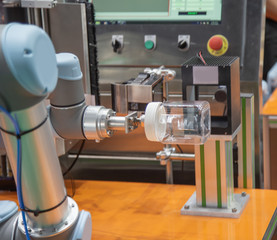 Robot lifting food jar to scan barcode in food industry