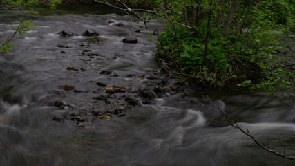 The rapids of the northern river in the dark taiga
