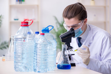 Young male chemist experimenting in lab