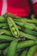 Open organic green peas in a pile