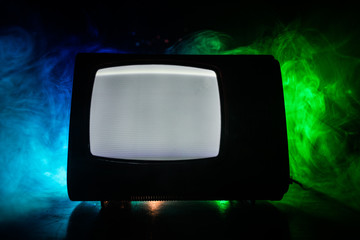 Old vintage red TV with white noise on dark toned foggy background. Retro old Television reciever no signal