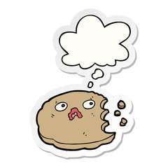 cartoon bitten cookie and thought bubble as a printed sticker