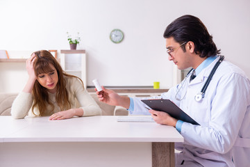 Young female patient discussing with male psychologist personal 