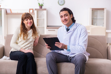 Young female patient discussing with male psychologist personal 