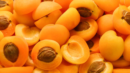 Ripe juicy orange apricots slices fruit background.