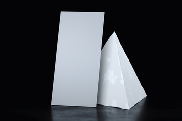 White blank realistic poster next to concrete geometric figure. 3d rendering.