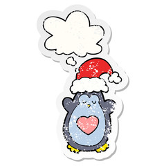 cute christmas penguin and thought bubble as a distressed worn sticker