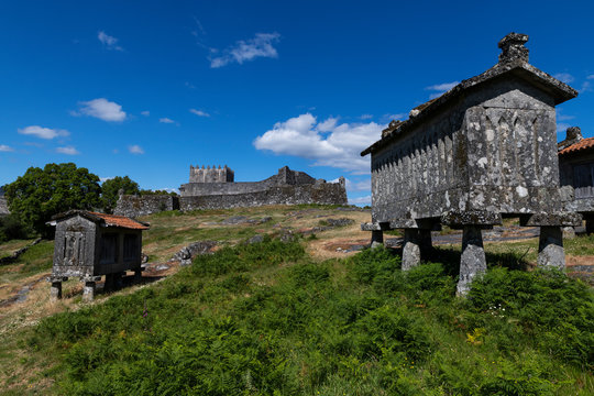 View of the granaries (espigueiros) and medieval castle in the historic village of Lindoso, Portugal.