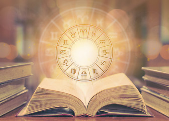 Zodiac sign horoscope astrology and constellation study for foretell and fortune telling education course concept with horoscopic wheel over old book in school library