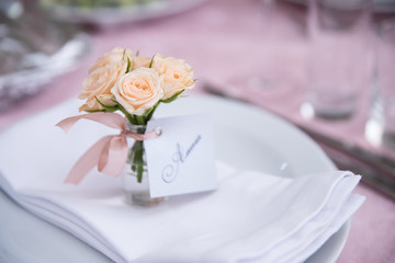Wedding decorated table. Luxury light decor on table in restaurant. Beautifully elegant decorated table for holiday.