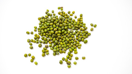 Scattered green grains of Mung Beans on a white background, top view. Healthy vegetarian food. Food background concept.