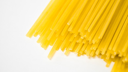 Yellow italian pasta. Long spaghetti. Raw spaghetti. Food background concept. Italian food and menu concept. 