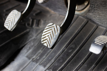 Three driving pedal with a manual transmission. Pedals in the car. Manual gearbox. Black three pedals in the car