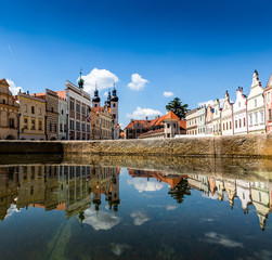 Fototapeta premium Main square of Telc city, a UNESCO World Heritage Site, on a sunny day with blue sky and clouds, South Moravia, Czech Republic.
