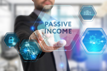 The concept of business, technology, the Internet and the network. A young entrepreneur working on a virtual screen of the future and sees the inscription: Passive income
