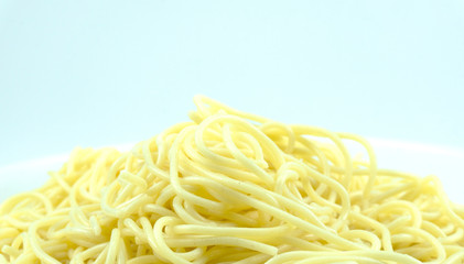 Yellow long spaghetti on white background, Blank for design, food concept..