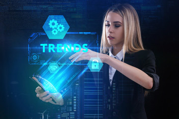 The concept of business, technology, the Internet and the network. A young entrepreneur working on a virtual screen of the future and sees the inscription: Trends