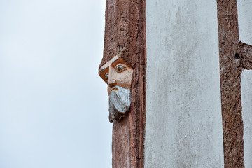 Close-up of faces wood carved in old houses in Rochefort-en-Terre, French Brittany