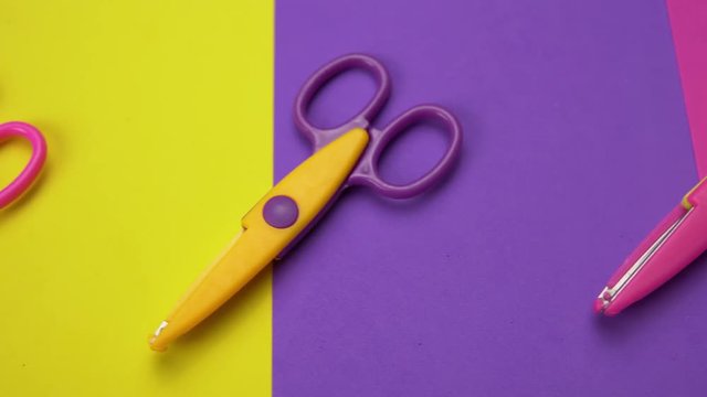 Set of a variety of wavy blade scissors for scrapbooking on colorful paper moves from right to left. Abstract minimal background with space for text.