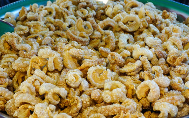 Deep fried or pork snack on tray at food market, pork rind, pork scratching ,pork crackling,snack meal,high cholesterol