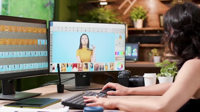 Photographer uses professional photo editing software or application in modern and cozy agency office