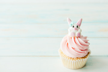 One cupcake on a wooden table. Copy space