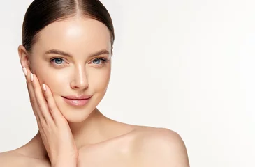 Beautiful Young Woman with Clean Fresh Skin . Facial  treatment   . Cosmetology , beauty  and spa . Nice and attractive girl with a pleasant smile.