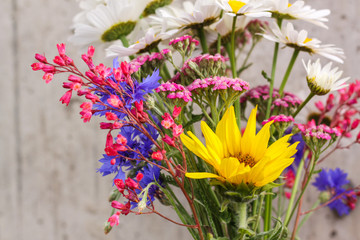 Bouquet of field flowers with sunflower chamomile, cornflowers