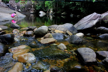 Forest river waterfall view.Mountain stream with blurred motion of waterfall. 