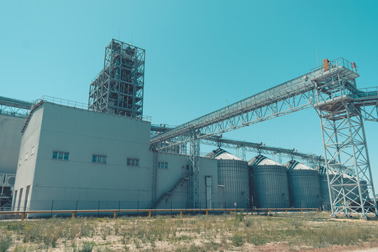 Svetlovodsk, Ukraine  &ndash; 27 May, 2018: Modern Agricultural Silos against blue sky. Storage and drying of grains, wheat, corn, soy, sunflower. Agricultural silo at feed mill factory