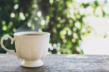 aroma coffee of cup with smoke on wooden table in the morning Copy Space for your text.