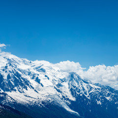 Fototapeta na wymiar the mont blanc massif and the aguille du midi in the french alpine valley of chamonix showing clear blue skies and snow capped peaks during spring