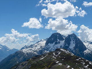 Fototapeta premium the mont blanc massif and the aguille du midi in the french alpine valley of chamonix showing clear blue skies and snow capped peaks during spring