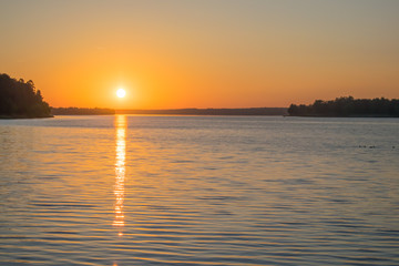 dawn of the red sun on the river