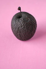 Rotten apple painted black