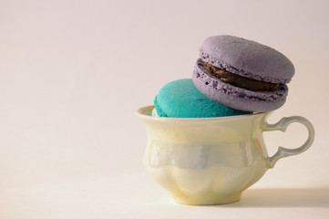 Delicious isolated macaroons with a fragrant cup of coffee