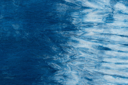 Pattern of blue tie batik dye on cotton cloth, Dyed indigo fabric background and textured