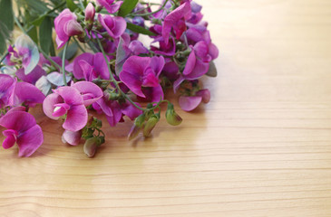 bunch of pink flowers lying on a wooden table