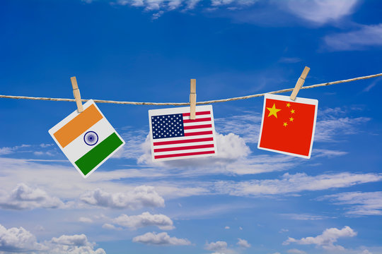 Flags of USA, China and India on the pictures hanging on the ropes/usa china trade war concept.