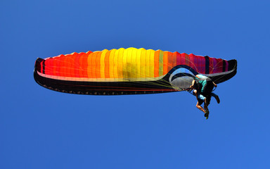 paraglider flying on the blue sky