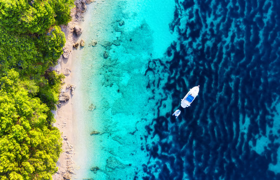 Yacht on the water surface from top view. Turquoise water background from top view. Summer seascape from air. Croatia. Travel - image © biletskiyevgeniy.com