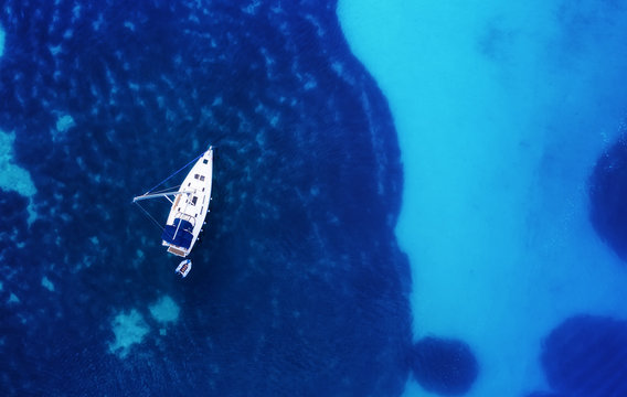 Yacht on the water surface from top view. Turquoise water background from top view. Summer seascape from air. Croatia. Travel - image