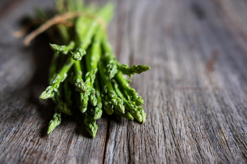Bunch of fresh asparagus on old wooden table