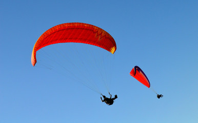 paraglider flight through the blue sky